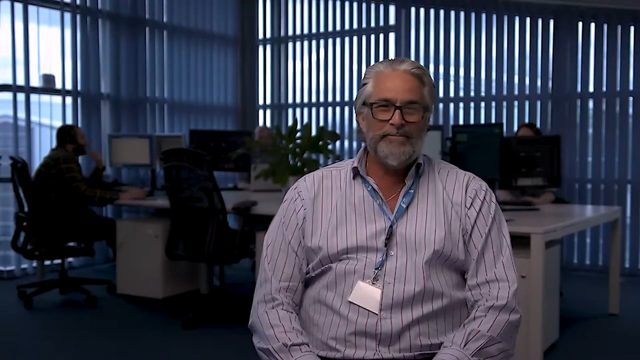 Manager interviewed in his office for a 1st Choice company film