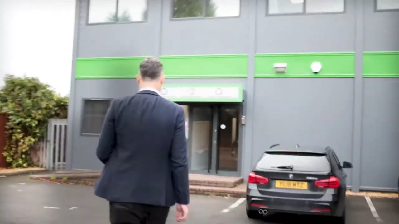 Man in a suit walking up to the Q Financial Services office, from a promotional film we made