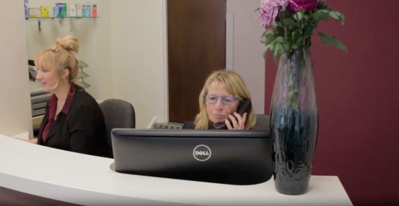 Two receptionists at a front desk, from a company film we made
