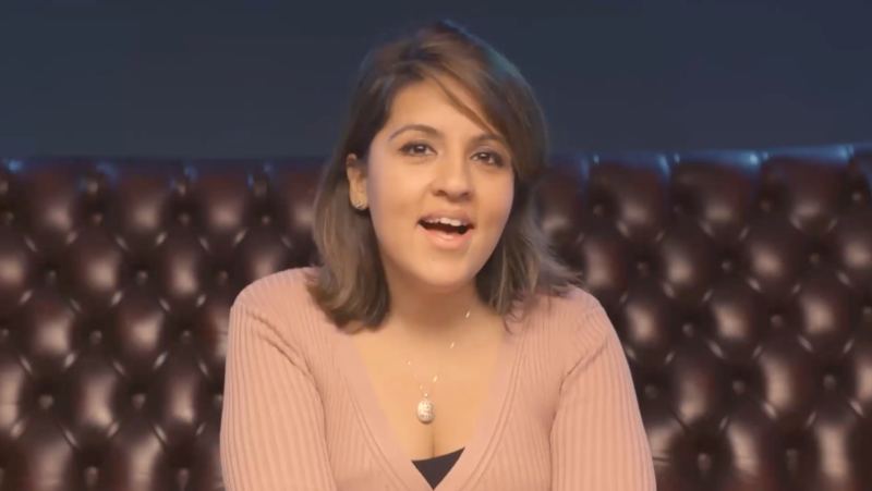 A presenter speaking to camera on a leather sofa, from a vlog we produced