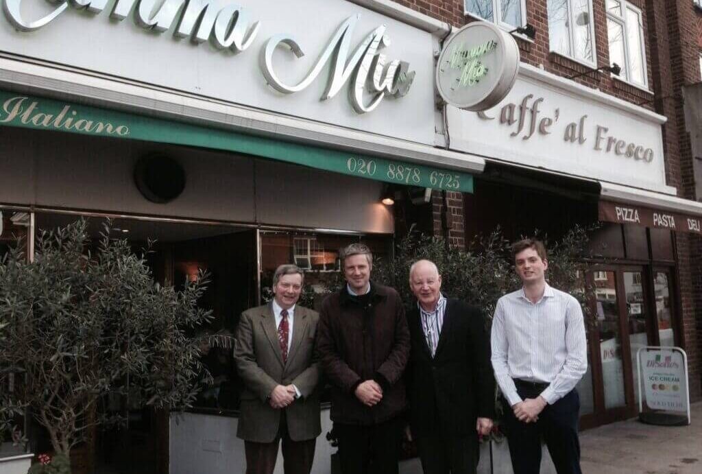 Brian with colleagues outside an office building