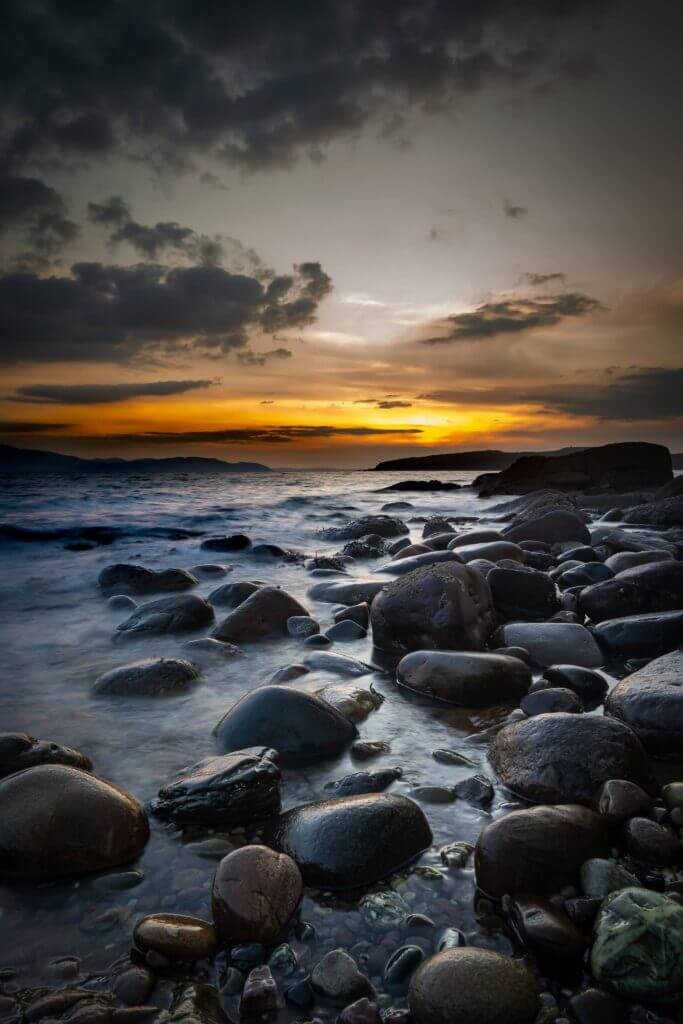 Sunset over dark rocks, photographed by David Barco