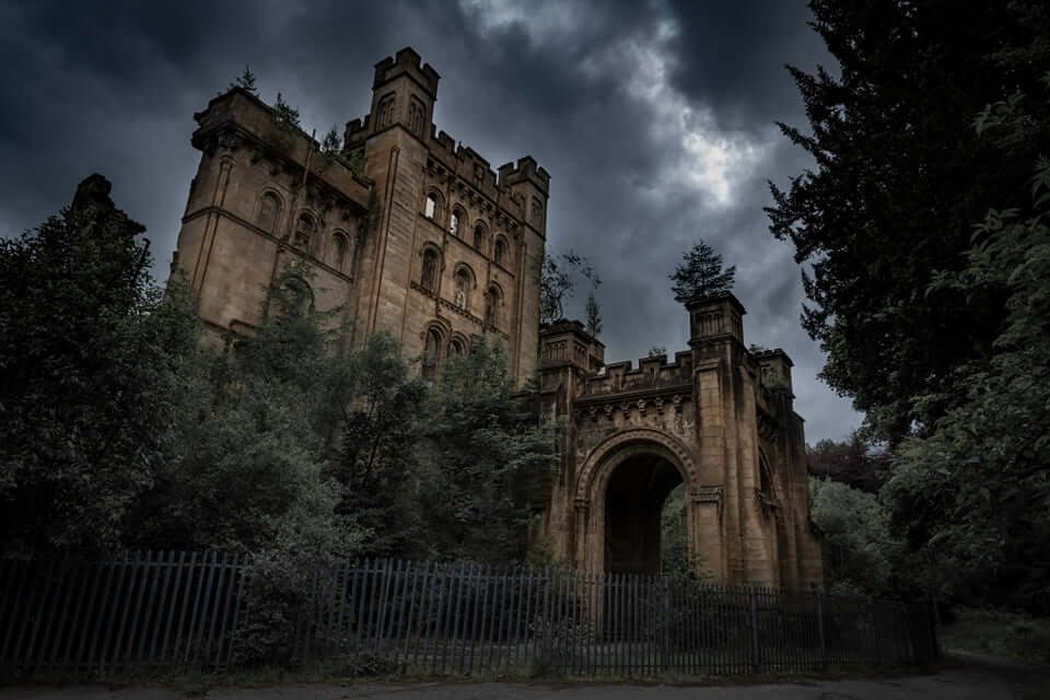 A ruined castle under a stormy sky, photographed by David Barco