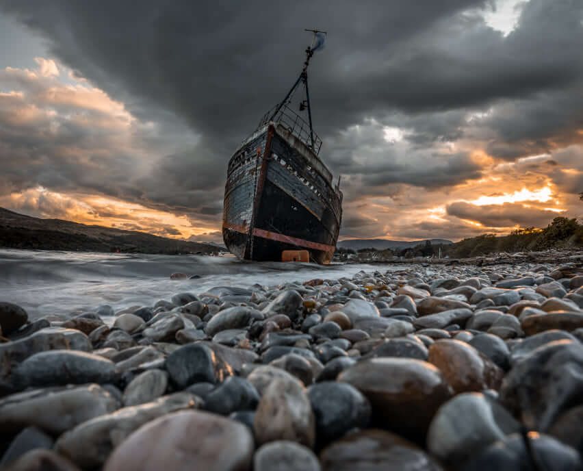 Smooth stones on a beach at dusk, photographed by David Barco