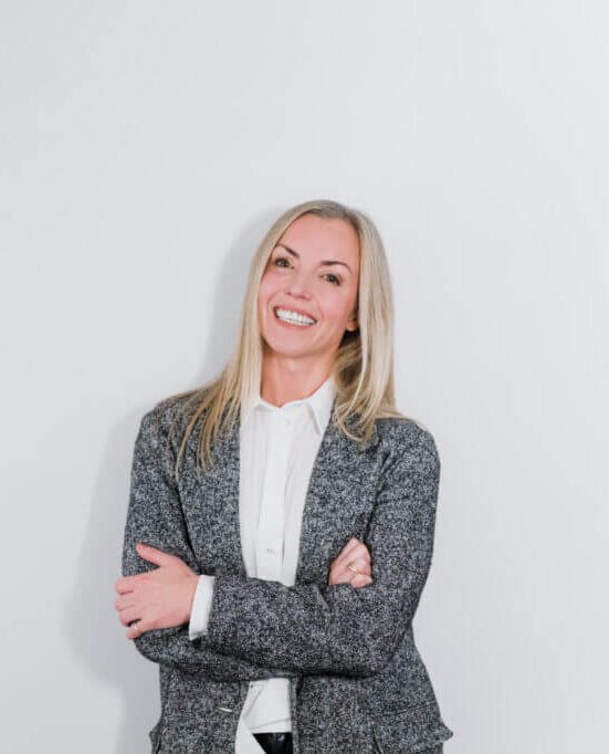 Nicole Bremner standing in a grey blazer