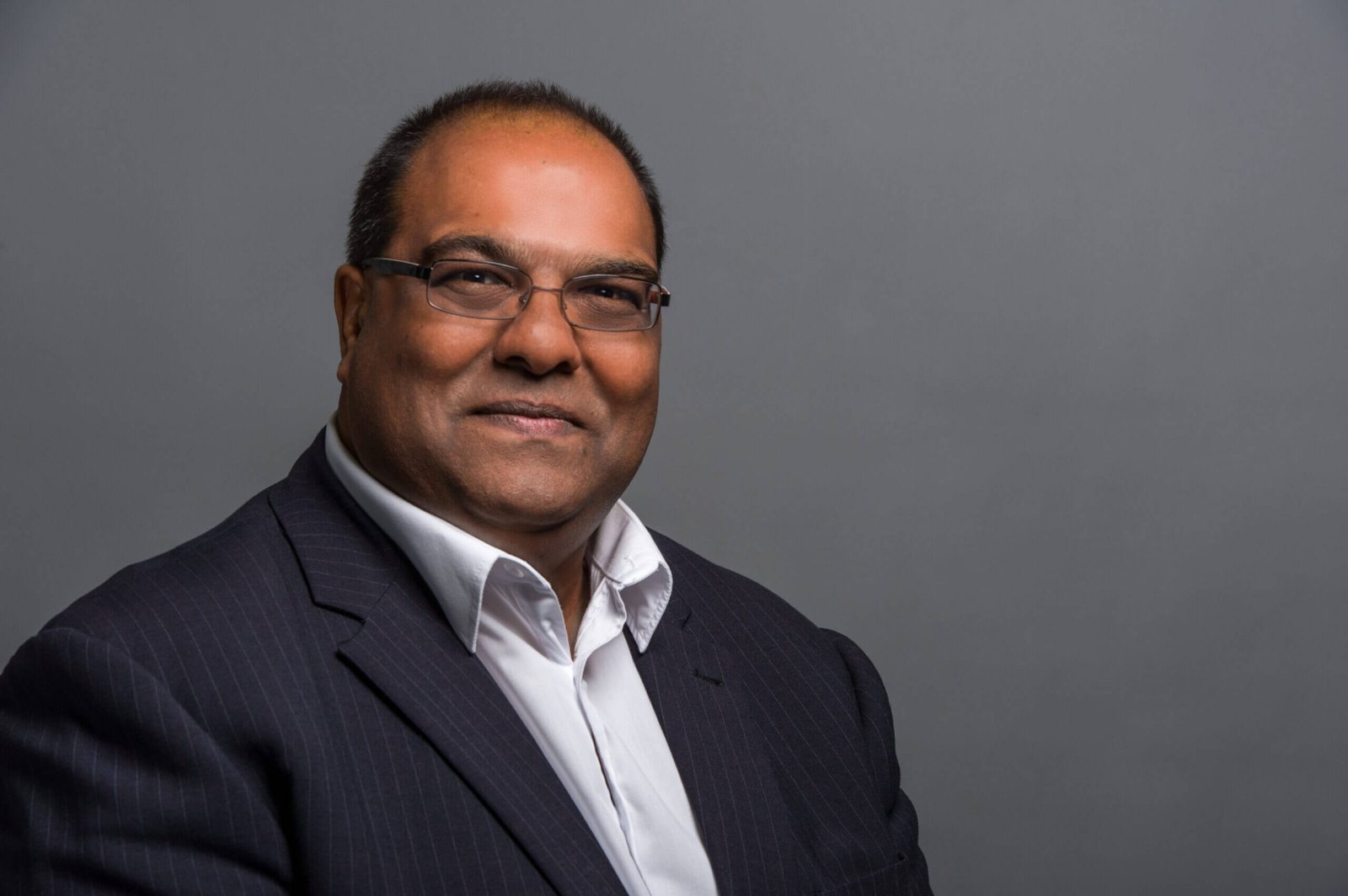 Shai Patel smiling in an office