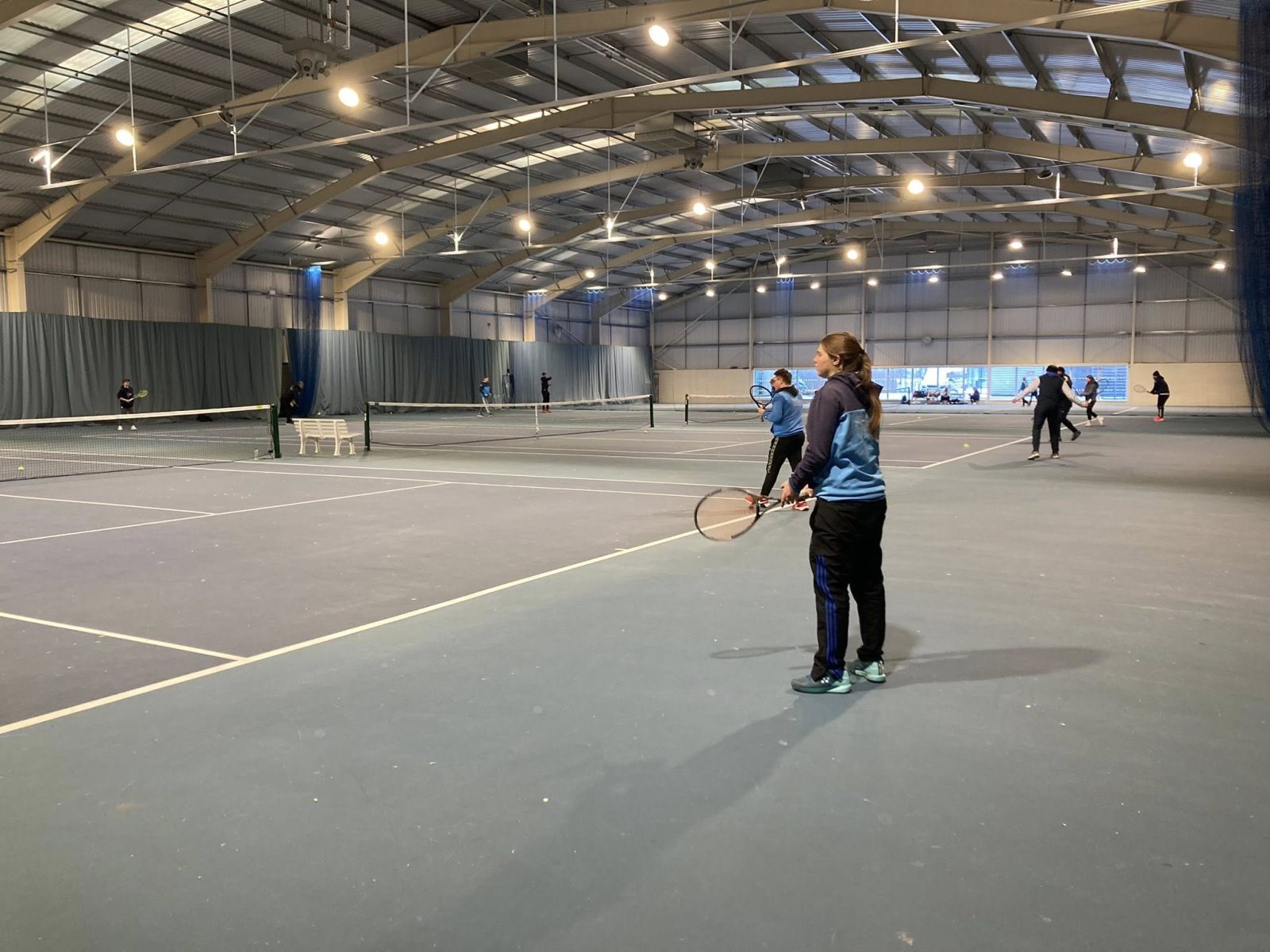 A coach on an indoor court during a session