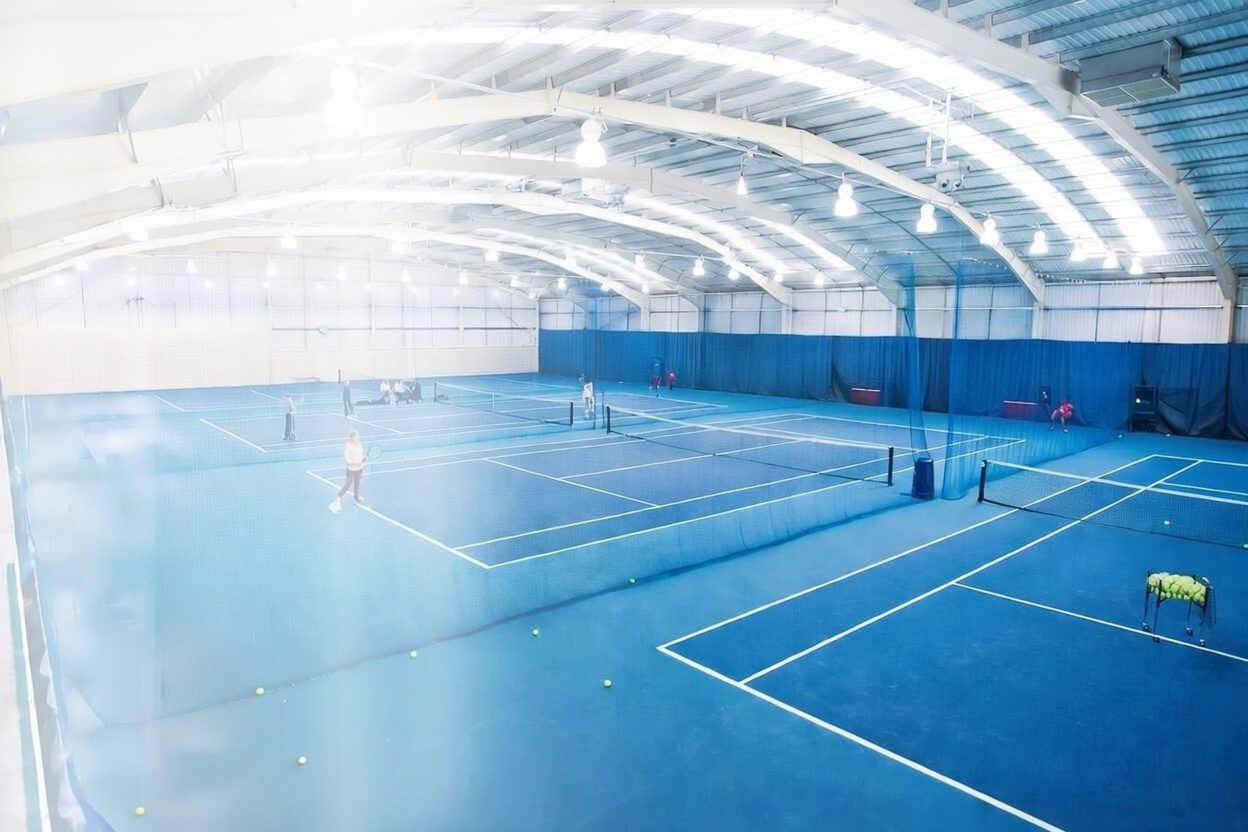 Indoor tennis courts at a We Do Tennis venue
